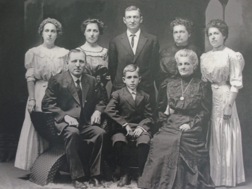 The Frank "Pa" Eckstein family portrait picturing eight family members in formal clothing.