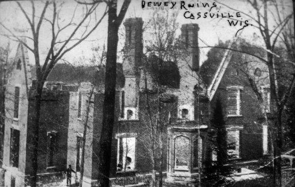 Elevated view of the ruins of the Nelson Dewey home burned in 1873. A man is standing near a door or window on the bottom left.